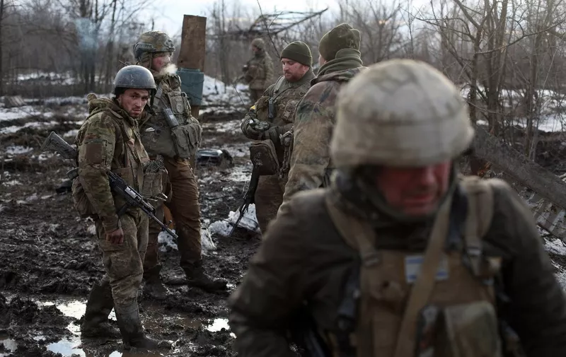 Servicemen of the Ukrainian Military Forces gather after fighting with Russian troops and Russia-backed separatists near the village of Zolote, in the Lugansk region on March 6, 2022. (Photo by Anatolii Stepanov / AFP)