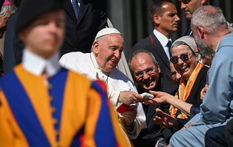 Pope Francis greets nuns at the end of his weekly general audience at Saint Peters' square in the Vatican, on April 26, 2023. (Photo by Vincenzo PINTO / AFP)