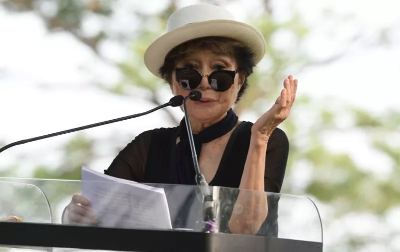 Yoko Ono speaks during a dedication ceremony for a giant tapestry, from Amnesty International, in honor of John Lennon on Ellis Island July 29, 2015 in New York. AFP PHOTO/DON EMMERT