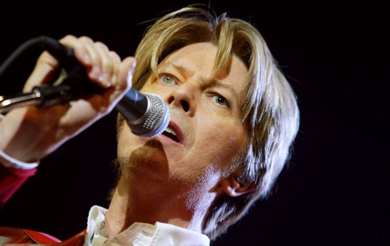 (FILES) This file photo taken on September 24, 2002 shows British singer David Bowie performing at the Zenith in Paris. 
British rock music legend David Bowie has died after a long battle with cancer, his official Twitter and Facebook accounts said on January 11, 2016. Bowie died on Januray 10 surrounded by family according to his social media accounts. The iconic musician had turned 69 only on January 8, which coincided with the release of "Blackstar", his 25th studio album. / AFP / MARTIN BUREAU