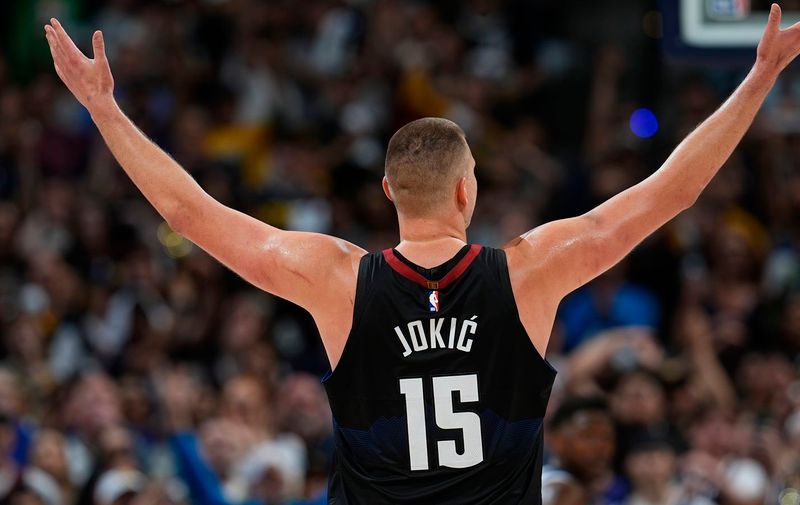 Denver Nuggets center Nikola Jokic gestures after guard Jamal Murray hit a basket against the Minnesota Timberwolves late in the second half of Game 5 of an NBA basketball second-round playoff series Tuesday, May 14, 2024, in Denver (AP Photo/David Zalubowski)