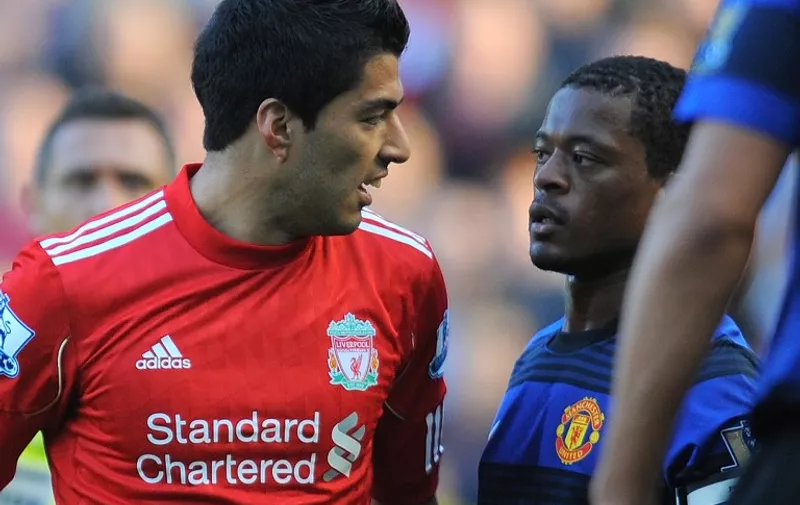 Liverpool's Uruguayan forward Luis Suárez (L) exchanges words with Manchester United's French defender Patrice Evra during the English Premier League football match between Liverpool and Manchester United at Anfield in Liverpool, north-west England, on October 15 2011. Liverpool have denied on October 16 Suarez abused Evra during the match, the BBC reported. French and British media quoted Evra after the game as telling French broadcaster Canal+ that Suarez had racially abused him several times during the match.    /
RESTRICTED TO EDITORIAL USE. No use with unauthorized audio, video, data, fixture lists, club/league logos or live services. Online in-match use limited to 45 images, no video emulation. No use in betting, games or single club/league/player publications.