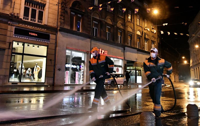 Workers washing streets with water and sanitising solution, in Sarajevo, late on March 20, 2020.   Bosnia records a rise in numbers of infected people who have developed clinical symptoms ad now has 89 patients infected with COVID-19. As of March 21, a new set of strict measures in battling corona virus include 14 day quarantine to be imposed on all Bosnian citizens returning to Bosnia and Herzegovina from other countries. With that purpose, armed forces set up improvised quarantine camps near all open border crossings with neighboring countries.,Image: 508123331, License: Rights-managed, Restrictions: , Model Release: no