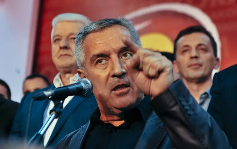 Montenegrin Prime Minister Milo Djukanovic and leader of ruling Democratic Party of Socialists speaks to his supporters after parliamentary elections in Podgorica on October 17, 2016. 
Montenegro's veteran premier Milo Djukanovic's party was leading in Sunday's tinderbox election during which authorities arrested 20 Serbs and accused them of planning attacks and hijacking the polls. / AFP PHOTO / SAVO PRELEVIC