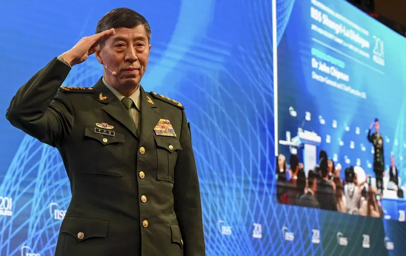 China's Minister of National Defence Li Shangfu salutes the audience before delivering a speech during the 20th Shangri-La Dialogue summit in Singapore on June 4, 2023. (Photo by Roslan RAHMAN / AFP)