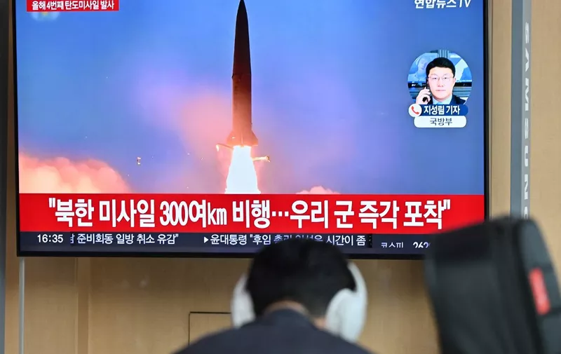 A man sits in front of a television screen showing a news broadcast with file footage of a North Korean missile test, at a railway station in Seoul on April 22, 2024. North Korea has fired an unidentified ballistic missile into the sea off South Korea's east coast, Seoul's military said on April 22, the latest in an apparent volley of tests by Pyongyang this year. (Photo by Jung Yeon-je / AFP)