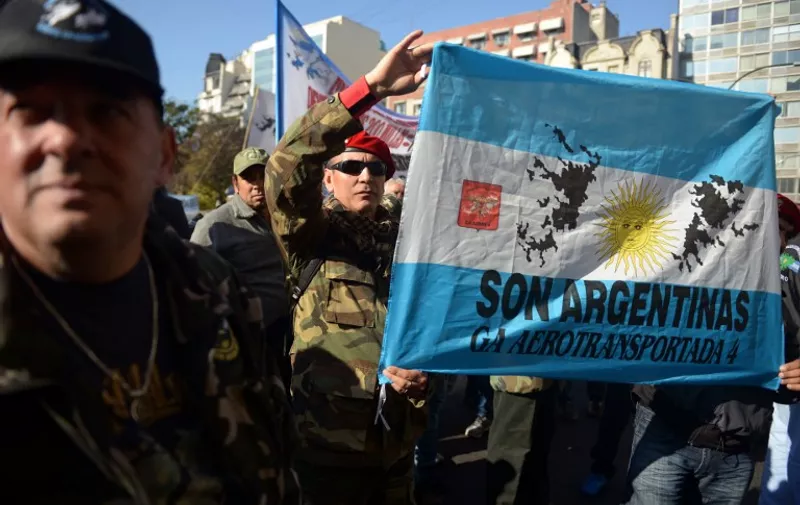 Veterans of the 1982 Falklands (Malvinas) War between Great Britain and Argentina, take part in a protest outside the Argentinian Supreme Court in Buenos Aires on June 16, 2015. The veterans demonstrated against a ruling of the Supreme Court that recognized the status of war veteran to a retired noncommissioned officer who was in the Argentinian mainland and not in the Falkland Islands during the war. AFP PHOTO / EITAN ABRAMOVICH