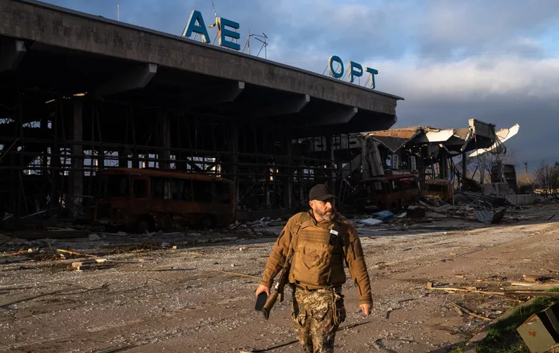 A Ukrainian soldier walks past a destroyed building of the International Airport of Kherson in the village of Chornobaivka, outskirts of Kherson, on November 19, 2022, amid the Russian invasion of Ukraine. (Photo by Ihor TKACHOV / AFP)