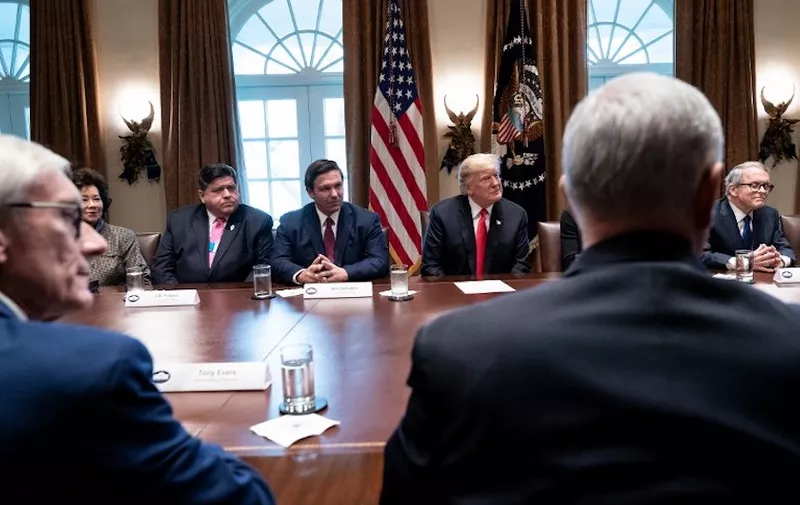 (L-R) Wisconsin Governor-elect  Tony Evers, US Secretary of Transportation Elaine Chao, Illinois Governor-elect J.B. Pritzker, Florida Governor-elect Ron DeSantis, US President Donald Trump, US Vice President Mike Pence, and Ohio Governor-elect Mike DeWine sit after a meeting with governors-elect in the Cabinet Room of the White House on December 13, 2018 in Washington, DC. (Photo by Brendan Smialowski / AFP)