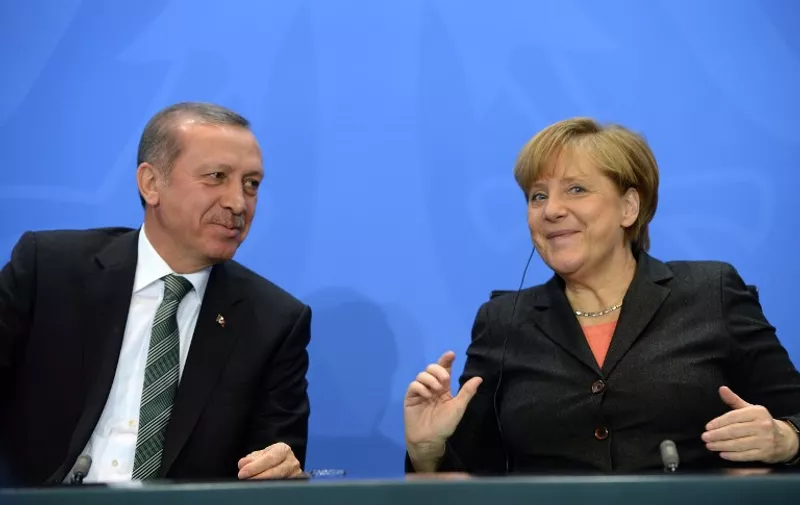 Turkey's Prime Minister Recep Tayyip Erdogan (L) and German Chancellor Angela Merkel (L) attend a press conference on February 4, 2014 in Berlin after their meeting. Turkish Prime Minister Recep Tayyip Erdogan urged Germany Tuesday to step up support for Turkey's European Union entry bid but acknowledged his country must also press on with reforms. AFP PHOTO / PATRIK STOLLARZ