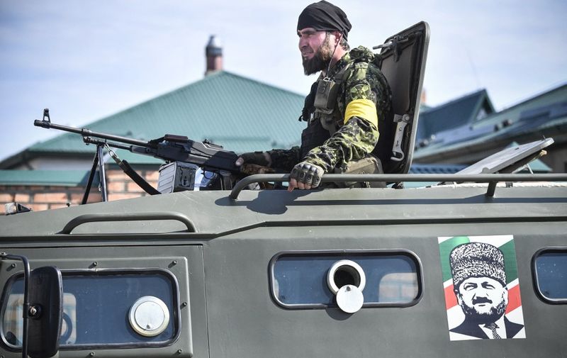 A Chechen special force trooper sits atop an APC decorated with a portrait of former Chechen president Akhmad Kadyrov, the father of the current Chechen leader Ramzan Kadyrov, during a training session at a 'Russian Spetsnaz University' special force training centre in the town of Gudermes in Chechnya on July 25, 2019. (Photo by Alexander NEMENOV / AFP)