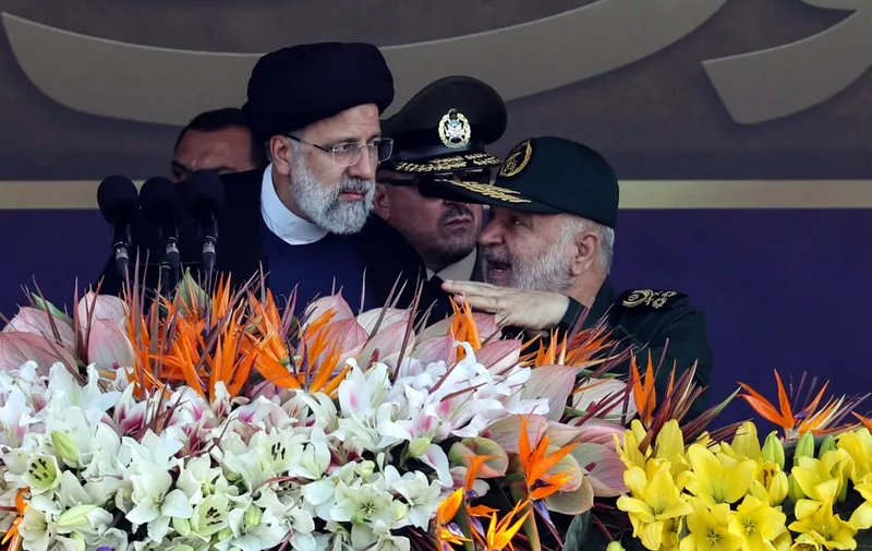 Iran's President Ebrahim Raisi (L) listens to Iranian Revolutionary Guard commander-in-chief Hossein Salami during the annual military parade marking the anniversary of the outbreak of the devastating 1980-1988 war with Saddam Hussein's Iraq, in Tehran on September 22, 2023. (Photo by AFP)