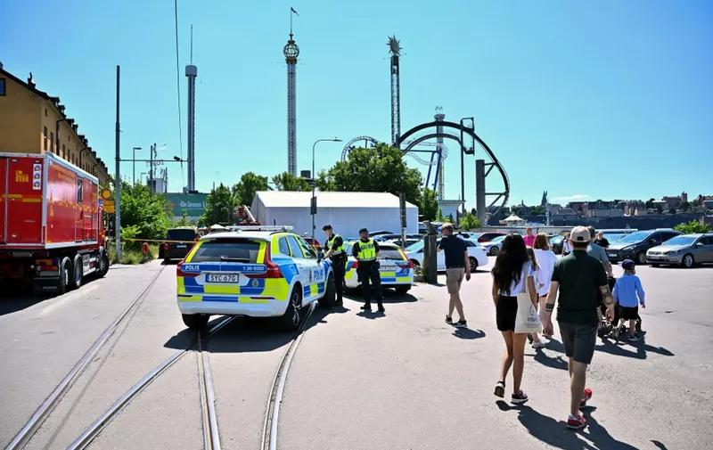 A photo taken on June 25, 2023 shows police at the Grona Lund amusement park, after an accident occurred in the 'Jetline' roller coaster leaving one person dead. A carriage in the 'Jetline' roller coaster has derailed and fallen from a height of several meters. One person died and several people have been injured, according to Swedish media reports on June 25. The amusement park is being evacuated and the police have set up cordons. (Photo by Claudio BRESCIANI / various sources / AFP) / Sweden OUT