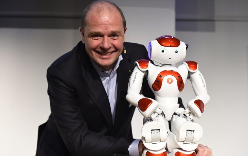 Co-Chief Executive Officer of QBMT/Zora Robotics Fabrice Goffin poses next to robot Mario before a news conference at the International Tourism Fair ITB in Berlin on March 10, 2016.
The humanoid robot Mario developped by Belgian company QBMT is used to help at the reception desk of a hotel in Belgium.  / AFP / TOBIAS SCHWARZ