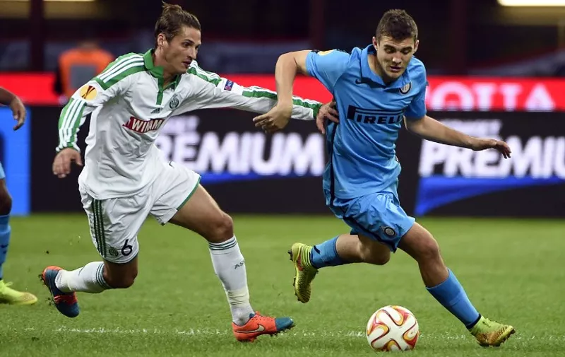 Saint-Etienne's French midfielder Jeremy Clement (L) vies for the ball with Inter Milan's Croatian midfielder Mateo Kovacic during the UEFA Europa League football match Inter Milan vs Saint-Etienne at the San Siro Stadium stadium in Milan on October 23, 2014. AFP PHOTO / OLIVIER MORIN
