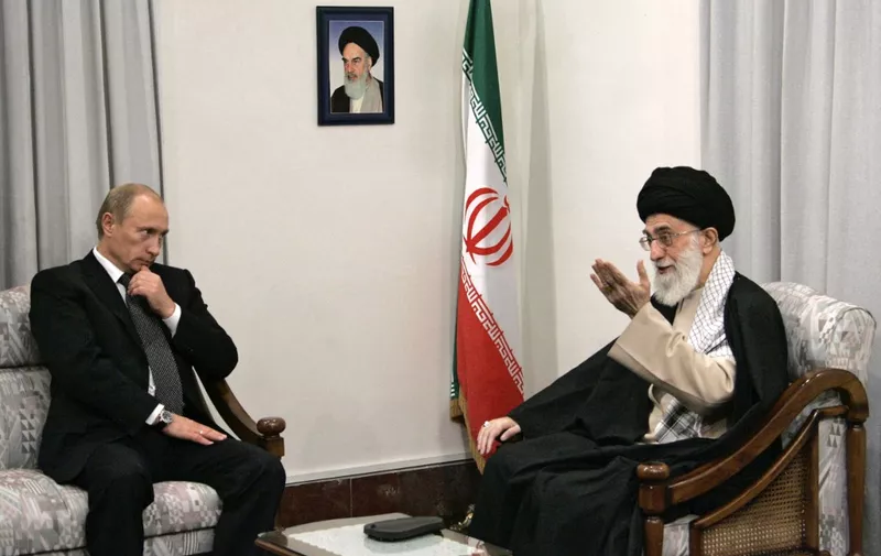 A picture made available 17 October 2007 shows Russian President Vladimir Putin (L) meeting with Iranian supreme leader Ayatollah Ali Khamenei (R) in Tehran, 16 October 2007. On the wall is a portrait of the late Iranian revolutionary founder Ayatollah Ruhollah Khomeini. "Vladimir Putin will remain national leader, regardless of the post that he holds," wrote Boris Gryzlov, head of the ruling United Russia party, in the 17 October 2007 government newspaper Rossiiskaya Gazeta. 
  AFP PHOTO / RIA NOVOSTI / KREMLIN POOL / MIKHAIL KLIMENTYEV (Photo by MIKHAIL KLIMENTYEV / POOL / AFP)