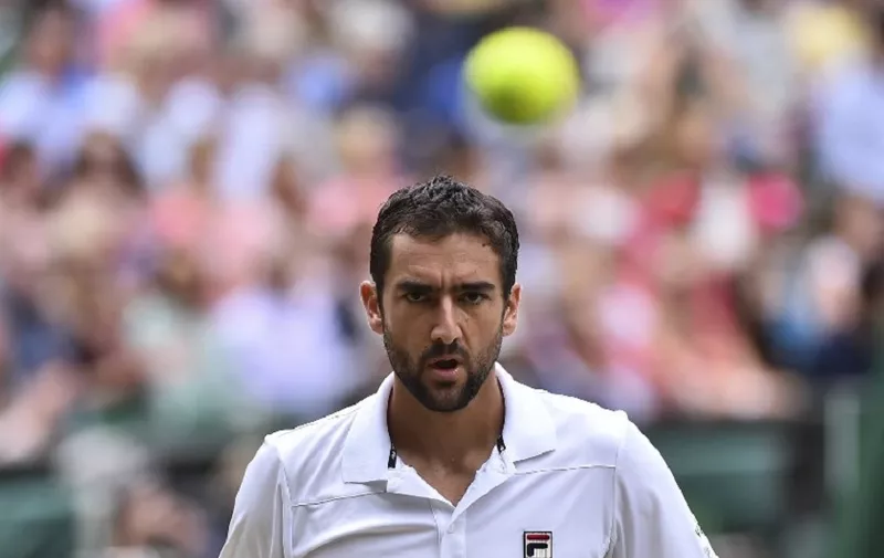 Croatia's Marin Cilic reacts against US player Sam Querrey during their men's singles semi-final match on the eleventh day of the 2017 Wimbledon Championships at The All England Lawn Tennis Club in Wimbledon, southwest London, on July 14, 2017. / AFP PHOTO / Glyn KIRK / RESTRICTED TO EDITORIAL USE