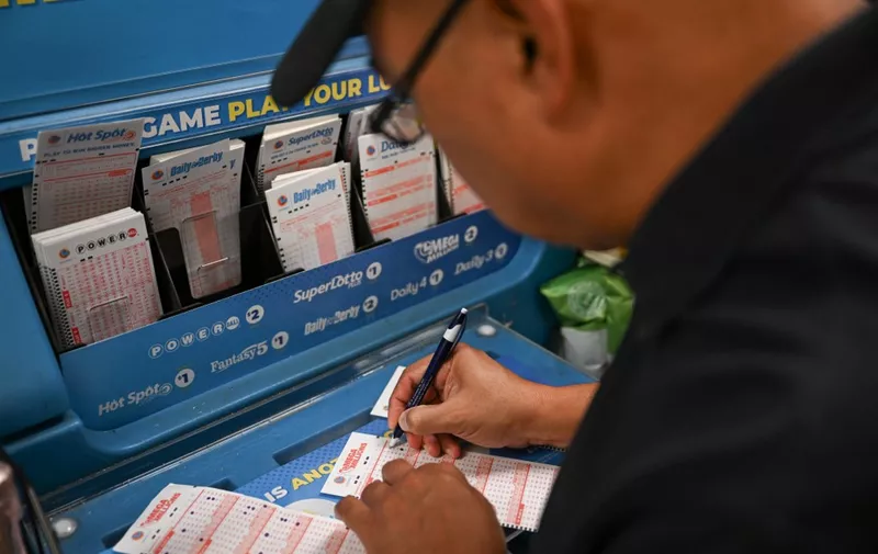 CALIFORNIA, USA - AUGUST 8: A person plays lottery at a 7-eleven store as Mega Millions jackpot reaches $ 1 billion 580 million, in Redwood City, California, United States on August 8, 2023. Tayfun Coskun / Anadolu Agency (Photo by Tayfun Coskun / ANADOLU AGENCY / Anadolu Agency via AFP)