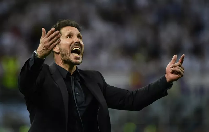 Atletico Madrid's Argentinian coach Diego Simeone celebrates after Real Madrid won the UEFA Champions League final football match between Real Madrid and Atletico Madrid at San Siro Stadium in Milan, on May 28, 2016. / AFP PHOTO / PIERRE-PHILIPPE MARCOU