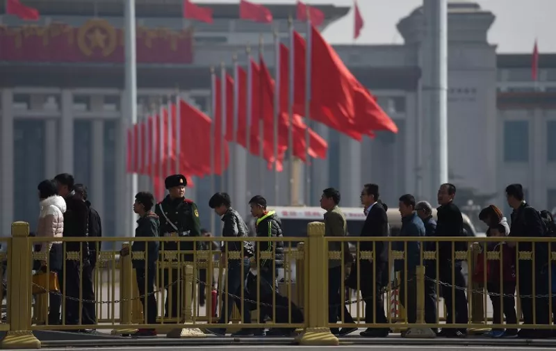 Visitors line up to enter Tiananmen Square, next to the Great Hall of the People, the venue for upcoming meetings of China's legislature in Beijing on March 2, 2015. China's Communist Party-controlled legislature, the National People's Congress (NPC), gathers in the capital this week with the "rule of law" high on the agenda. AFP PHOTO / Greg BAKER / AFP PHOTO / GREG BAKER