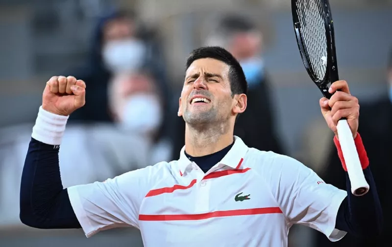 Serbia's Novak Djokovic celebrates after winning against  Spain's Pablo Carreno Busta during their men's singles quarter-final tennis match on Day 11 of The Roland Garros 2020 French Open tennis tournament in Paris on October 7, 2020. (Photo by Anne-Christine POUJOULAT / AFP)