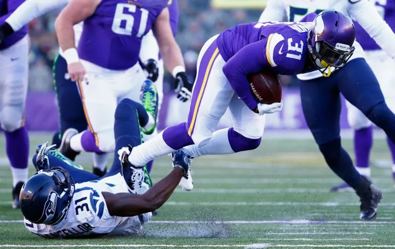 MINNEAPOLIS, MN - JANUARY 10: Kam Chancellor #31 of the Seattle Seahawks attempts to tackle Jerick McKinnon #31 of the Minnesota Vikings in the first half during the NFC Wild Card Playoff game at TCFBank Stadium on January 10, 2016 in Minneapolis, Minnesota.   Jamie Squire/Getty Images/AFP