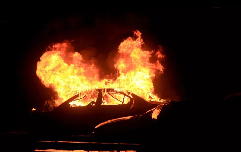 This picture taken on March 13, 2016, shows a burning car after a blast in Ankara.
An explosion ripped through a busy square in central Ankara on March 13, killing 27 people and wounding 75 more, with local media reports describing it as an attack. Ambulances rushed to the scene of the explosion on Kizilay square, a key shopping and transport hub close to the city's embassy area.
 / AFP / MEHMET OZER