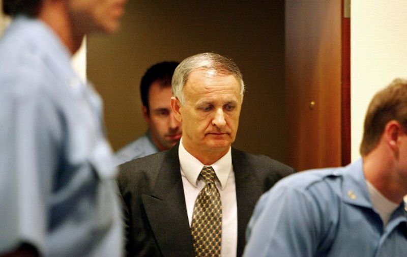 Bosnian general Radislav Krstic arrives in court for his appeal hearing at the International Criminal Tribunal for his part in the Srebrenica massacre, 19 April 2004. In a historic ruling Monday, the UN war crimes court declared that the 1995 massacre in Srebrenica was genocide, but reduced a conviction against Krstic to aiding and abetting genocide. The tribunal's appeals chamber reduced Krstic's conviction by ten years, from 45 to 35 years over the killing of more than 7,000 muslims in the UN protected enclave during the 1992-1995 war. AFP PHOTO/POOL/Paul Vreeker / AFP PHOTO / POOL / PAUL VREEKER