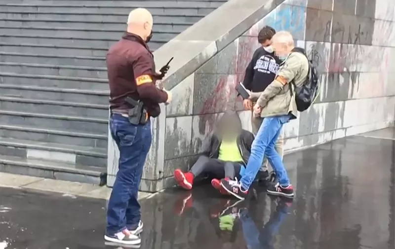 This grab taken from a video obtained by AFP shows French police detaining an alleged suspect after several people were injured near the former offices of the French satirical magazine Charlie Hebdo following an attack by a man wielding a knife in Paris on September 25, 2020. - A man armed with a knife seriously wounded two people on September 25, 2020, in a suspected terror attack outside the former offices of French satirical weekly Charlie Hebdo in Paris, three weeks into the trial of men accused of being accomplices in the 2015 massacre of the newspaper's staff. Charlie Hebdo had angered many Muslims around the world by publishing cartoons of the Prophet Mohammed, and in a defiant gesture ahead of the trial this month, it reprinted the caricatures on its front cover. (Photo by Laura CAMBAUD / AFP)