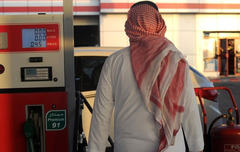 A Saudi man walks past a pump at a petrol station on December 28, 2015 in the Red Sea city of Jeddah. Saudi Arabia said it plans to review the prices of heavily-subsidised power and fuel as part of new measures introduced in the face of low oil prices.   AFP PHOTO / AMER HILABI / AFP / AMER HILABI