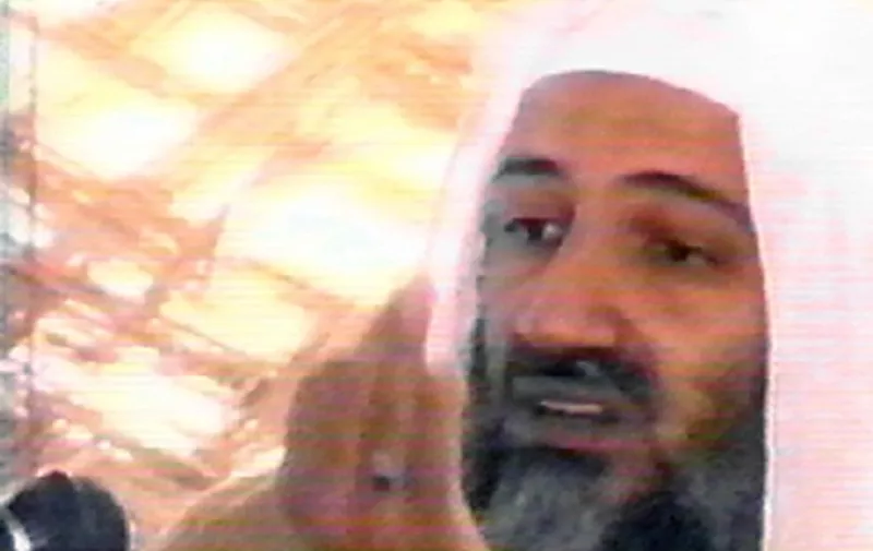 This undated video grab shows Saudi-born alleged terrorism mastermind Osama bin Laden speaking at an undisclosed location in Afghanistan from a video said to have been prepared by bin Laden himself. Copies of the tape, which shows him as well as al-Qaeda guerrilla fighters training at al-Faruq camp in Afghanistan, have been circulated to a limited number of Islamists. Bin Laden is America's prime suspect behind the September 11 terrorist attacks.     AFP PHOTO/HO