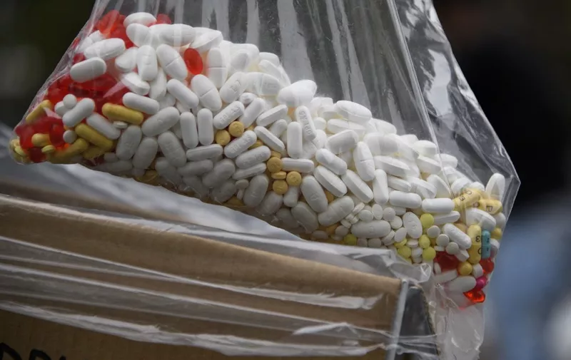 A bag of assorted pills and prescription drugs dropped off for disposal is displayed during the Drug Enforcement Administration (DEA) 20th National Prescription Drug Take Back Day at Watts Healthcare on April 24, 2021 in Los Angeles, California. According to the Centers for Disease Control and Prevention, the US has seen an increase in drug overdose deaths during the Covid-19 pandemic, accelerating significantly during the first months of the public health emergency, including deaths from opioids and counterfeit pills containing fentanyl. (Photo by Patrick T. FALLON / AFP)