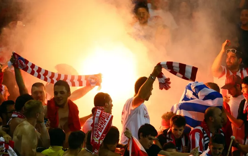 TORONTO, ON - JULY 24: Olympiacos FC fans light flares at the conclusion of the game against of AC Milan during International Champions Cup 2014 action at BMO Field July 24, 2014 in Toronto, Ontario, Canada.   Abelimages/Getty Images/AFP