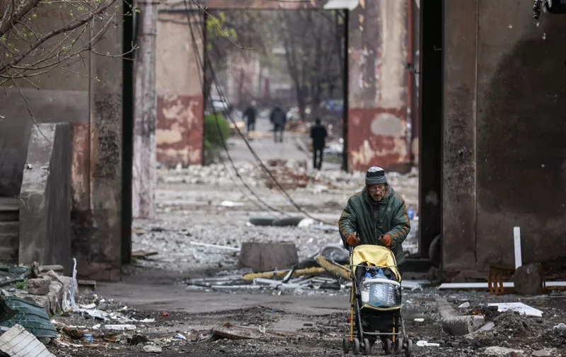 MARIUPOL, DONETSK REGION, UKRAINE - APRIL 16, 2022: A local resident pushes a baby stroller loaded with plastic bottles. The Russian Armed Forces are carrying out a special military operation in Ukraine. Sergei Bobylev/TASS,Image: 683561132, License: Rights-managed, Restrictions: , Model Release: no, Credit line: Profimedia