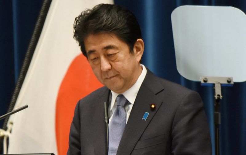 Japanese Prime Minister Shinzo Abe looks down as he delivers a war anniversary statement that neighbouring nations will scrutinise for signs of sufficient remorse over Tokyo's past militarism at his official residence in Tokyo on August 14, 2015.  Abe expressed deep remorse over World War II and said previous national apologies were unshakeable, but emphasised future generations should not have to keep saying sorry.    AFP PHOTO / Toru YAMANAKA