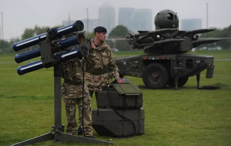 A Starstreak high velocity missile (HVM) system, which could play a role in providing air security during the Olympics, is manned by members of the British Royal Artillery as a Rapier ground-based air defence (GBAD) system stands in the backround (R) during a media demonstration at Blackheath in southeast London on May 3, 2012. Britain is to rehearse its security measures for the Olympic Games this week in a military exercise involving warships, fast jets, helicopters and dummy missiles, the Ministry of Defence said. Exercise Olympic Guardian, a land, sea and air drill, will take place in three phases from May 2-10 -- the first on the south coast, the second in London's airspace and the final phase on the River Thames. AFP PHOTO/CARL COURT (Photo by CARL COURT / AFP)