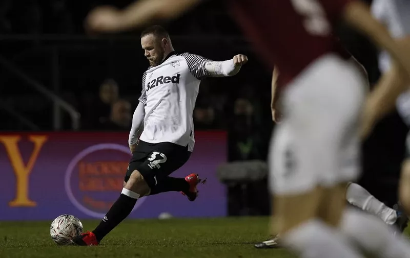 Derby County's English striker Wayne Rooney takes a free kick during the English FA Cup fourth round football match between between Northampton Town and Derby County at the Sixfields Stadium in Northampton, central England on January 24, 2020. (Photo by Adrian DENNIS / AFP) / RESTRICTED TO EDITORIAL USE. No use with unauthorized audio, video, data, fixture lists, club/league logos or 'live' services. Online in-match use limited to 120 images. An additional 40 images may be used in extra time. No video emulation. Social media in-match use limited to 120 images. An additional 40 images may be used in extra time. No use in betting publications, games or single club/league/player publications. /