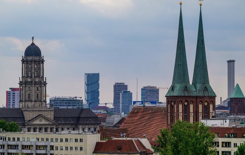 A view taken from the Berlin Cathedral (Berliner Dom) shows the tower of the Alt Stadthaus (L), the spires of the Nikolaikirche church (R) and the newly completed "Edge East Side Berlin" tower (2nd from L), in Berlin on April 24, 2024. (Photo by John MACDOUGALL / AFP)
