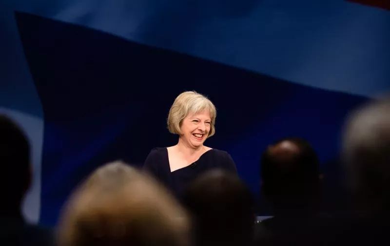 Britain's Home Secretary Theresa May addresses delegates on the third day of the annual Conservative party conference in Manchester, north west England, on October 6, 2015. AFP PHOTO / LEON NEAL / AFP PHOTO / LEON NEAL