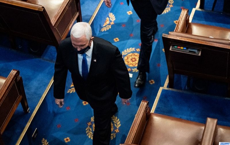 WASHINGTON, DC - JANUARY 06: U.S. Vice President Mike Pence walks off the House floor during a joint session of Congress to certify the 2020 Electoral College results on January 6, 2021 in Washington, DC. Congress held a joint session today to ratify President-elect Joe Biden's 306-232 Electoral College win over President Donald Trump. A group of Republican senators said they would reject the Electoral College votes of several states unless Congress appointed a commission to audit the election results.   Erin Schaff-Pool/Getty Images/AFP