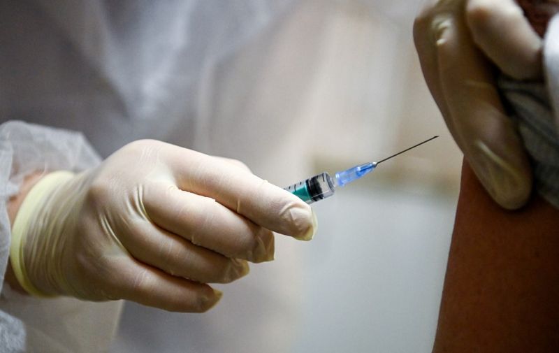 A nurse proceeds to a vaccination against the coronavirus disease (COVID-19) by Sputnik V (Gam-COVID-Vac) vaccine at a clinic in Moscow on December 5, 2020, amid the ongoing coronavirus disease pandemic. - Russian President has told authorities to begin "large-scale" vaccinations among at-risk populations. The drugs should be made generally available to the Russian public in early 2021. (Photo by Kirill KUDRYAVTSEV / AFP)