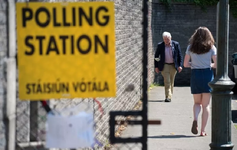 Voters arrive and leave St. Patrick's Boys National School polling station in Drumcondra, Dublin, to vote in the Irish referendum on liberalising abortion law on May 25, 2018.
Irish voters headed to the polls Friday to vote in a landmark referendum on whether the country should liberalise some of the strictest abortion laws in Europe. Ireland's current abortion laws ban all terminations except in cases where the mother's life is at risk. Draft legislation already prepared in case of a pro-choice vote in Friday's historic referendum would legalise abortions in the first 12 weeks of pregnancy and up to 24 weeks for health reasons. / AFP PHOTO / Barry CRONIN