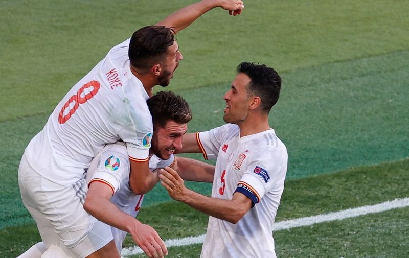 Spain's defender Aymeric Laporte (C) celebrates scoring his team's second goal during the UEFA EURO 2020 Group E football match between Slovakia and Spain at La Cartuja Stadium in Seville on June 23, 2021. (Photo by POOL / AFP)
