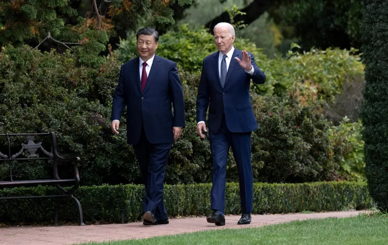 US President Joe Biden (R) and Chinese President Xi Jinping walk together after a meeting during the Asia-Pacific Economic Cooperation (APEC) Leaders' week in Woodside, California on November 15, 2023. Biden and Xi will try to prevent the superpowers' rivalry spilling into conflict when they meet for the first time in a year at a high-stakes summit in San Francisco on Wednesday. With tensions soaring over issues including Taiwan, sanctions and trade, the leaders of the world's largest economies are expected to hold at least three hours of talks at the Filoli country estate on the city's outskirts. (Photo by Brendan Smialowski / AFP)