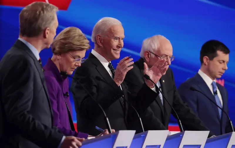 DES MOINES, IOWA - JANUARY 14: Tom Steyer (L), Sen. Elizabeth Warren (D-MA), Sen. Bernie Sanders (I-VT) and former South Bend, Indiana Mayor Pete Buttigieg (R) listen as former Vice President Joe Biden (C) speaks during the Democratic presidential primary debate at Drake University on January 14, 2020 in Des Moines, Iowa. Six candidates out of the field qualified for the first Democratic presidential primary debate of 2020, hosted by CNN and the Des Moines Register.   Scott Olson/Getty Images/AFP