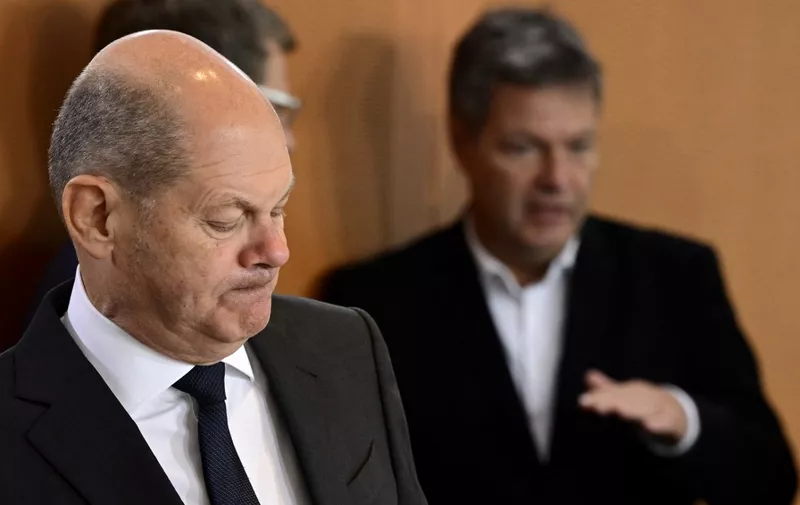 German Chancellor Olaf Scholz (L) is pictured as German Minister of Economics and Climate Protection Robert Habeck is seen in the background during the weekly cabinet meeting at the Chancellery in Berlin on October 19, 2022. (Photo by John MACDOUGALL / AFP)