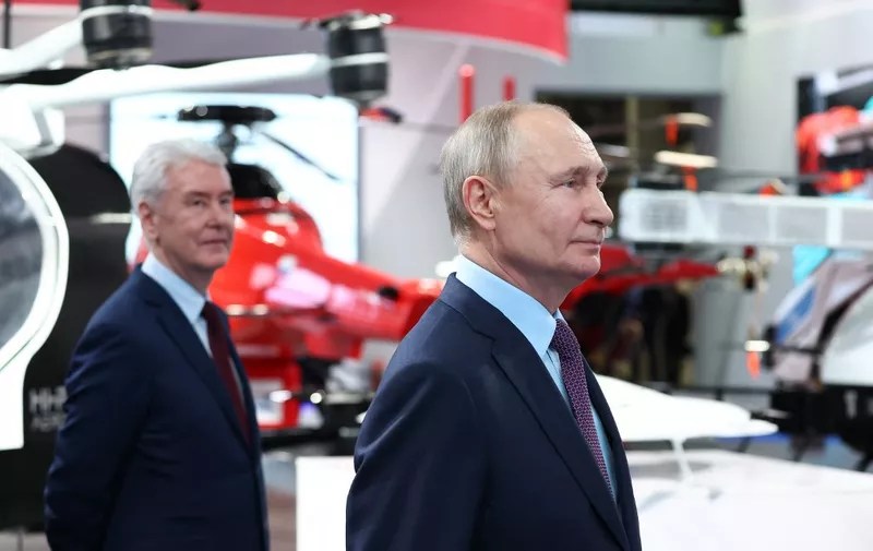 Russian President Vladimir Putin (R) and Moscow Mayor Sergei Sobyanin visit an exhibition of manufacturers and operators of unmanned aerial systems at the Rudnyovo industrial park in Moscow on April 27, 2023. (Photo by Artem Geodakyan / SPUTNIK / AFP)