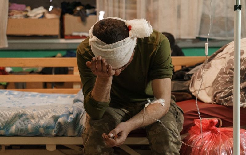 A newly arrived wounded soldier waits for treatment in a room of the military hospital in Zaporizhzhya, on March 31, 2022, amid Russian invasion of Ukraine. (Photo by emre caylak / AFP)