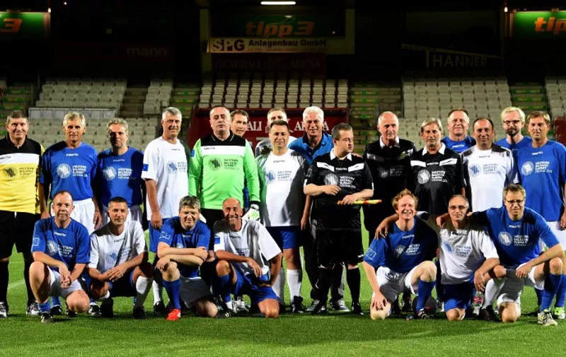 Prime Ministers and ministers of Balkan countries forming the Balkan team called "EU future" and Prime Ministers and ministers of EU countries pose for a team photo ahead of a friendly football match between team "EU" and "EU future" on the eve of the Western Balkan Summit in Vienna, on August 26, 2015.  AFP PHOTO / JOE KLAMAR