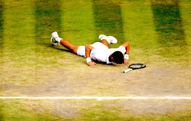LONDON, ENGLAND - JULY 14: Novak Djokovic of Serbia reacts after falling to the ground in his Men's Singles final against Roger Federer of Switzerland during Day thirteen of The Championships - Wimbledon 2019 at All England Lawn Tennis and Croquet Club on July 14, 2019 in London, England. (Photo by Shaun Botterill/Getty Images)